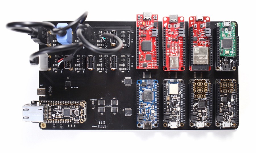Arena testing board with UART adapters and target microcontrollers